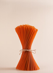 Red, tomato paste, raw, stands on the table. The ingredient is isolated on a pink background.