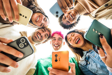 Group of young people using smart mobile phone device outside - Trendy technology concept with guys...