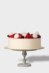 Bright, beautiful red berry cake lying on a cake stand. Isolated image. Cooled cake. Ice cream cake