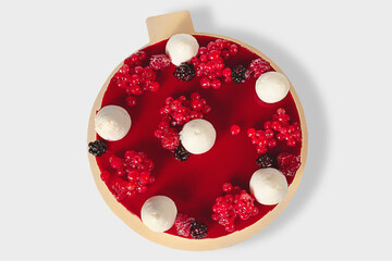 Bright, beautiful red berry cake lying on a cake stand. Isolated image. Cooled cake. Ice cream cake
