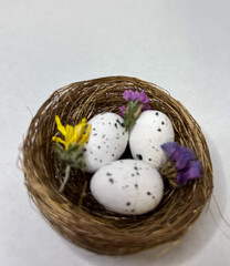 Easter eggs in a basket decorated with flowers and decor