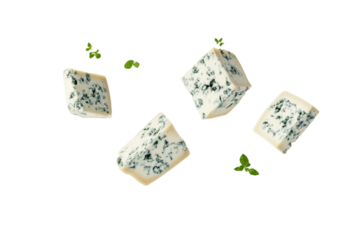 Close up of four pieces of blue cheese with green leaves on top, isolated