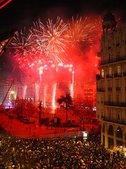 Red fireworks on Las Falles fire festival 2025. Pyrotechnic show. Plaza del Ayuntamiento, Valencia