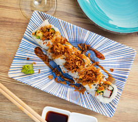 Crunch California roll, consist of rice, nori, lightly salted salmon, avocado, cheese, decorated...