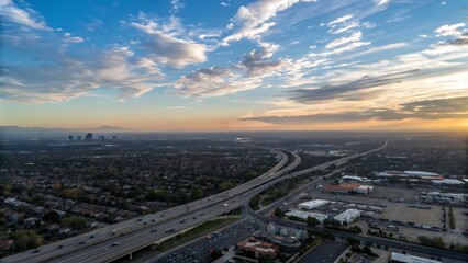 Fototapeta premium Symmetrical aerial view of sprawling highway loops amidst patches of green landscape.