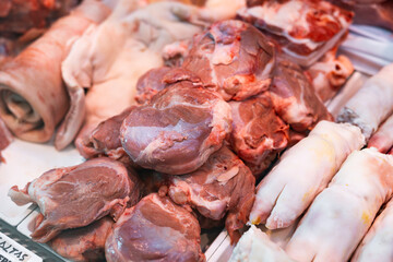 Raw pork meat laid out on counter in butcher shop