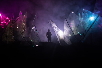 A silhouette of a person against the background of shattered glass. An abstract world made of glass shards. Surreal concept. Table top decoration.