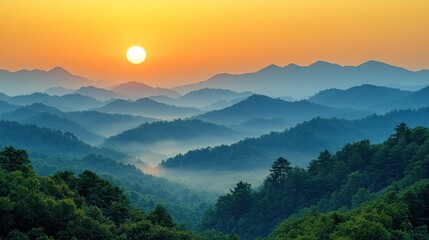 Obraz premium Majestic sunrise over misty mountain ranges.