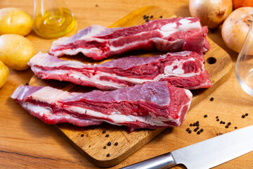 Raw beef brisket served with vegetables and seasonings