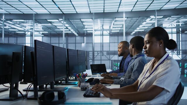 Data center engineers maintaining company network infrastructure by installing, configuring, troubleshooting and repairing hardware. Server hub workers ensuring optimal system performance, camera A