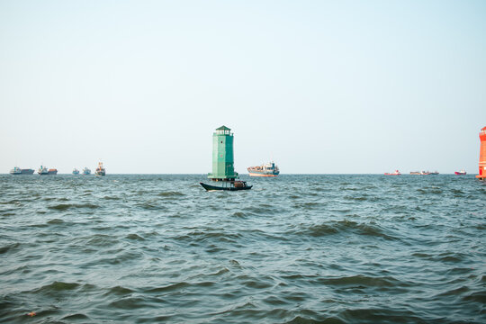 Small Boat and Lighthouses on a Calm Sea