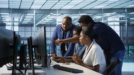 Teamworking engineers talking in server room, developing disaster recovery plans ensuring minimal...