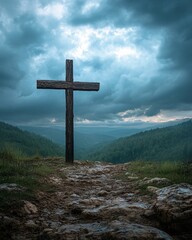 Religious cross on hill with dramatic sky