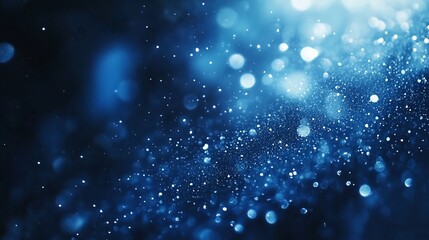Obraz premium Abstract blue background with sparkling glitter and bokeh effect