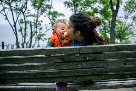 Mother and Baby Sharing a Moment on a Bench