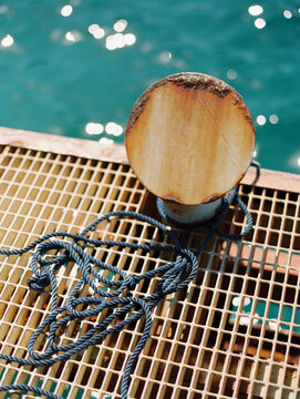 Rusted Bollard and Nautical Rope on Dock, Italy