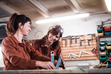 Smiling iron lettering artists at work