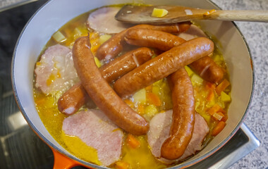 Hearty Sausage and Ham Stew Cooking in Pot