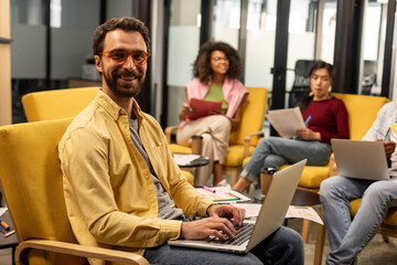 Smiling white man with laptop in his hands