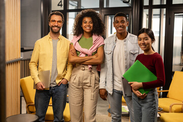 Group of four people smiling in office