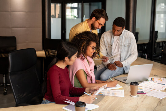 Group of young people with different races works in office