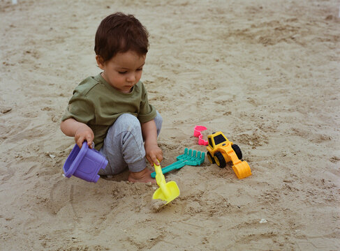 Todler Is Playing In The Sandbox