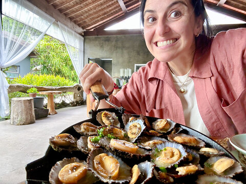 UGC woman selfie eating limpets  Azores, Sao Miguel 
