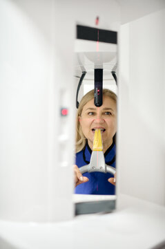 Attractive woman doing teeth roentgen at light medical clinic