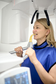 Attractive woman doing teeth roentgen at light medical clinic