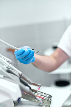 the dentist's hand holds instruments