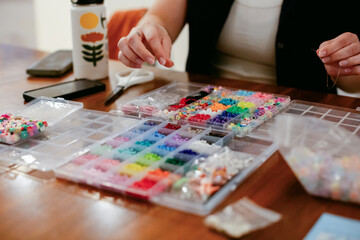 Closeup of Woman Choosing Beads for Friendship Bracelet