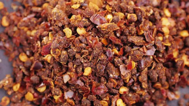 pile crushed red cayenne pepper, dried chili flakes and seeds isolated on white background