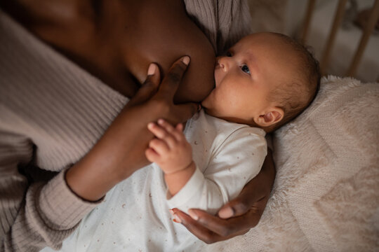 Little baby sucking nipple during breastfeeding