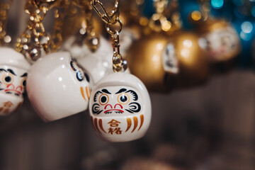 Traditional Japanese tourist souvenirs and gifts from Kyoto, Kansai, Japan, with daruma figures,...