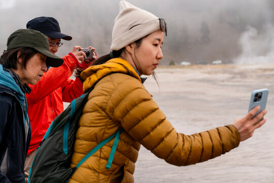 Tourist using cellphone taking picture
