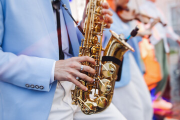 Concert view of saxophonist musician, saxophone sax player with vocalist and musical band during...