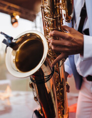Concert view of saxophonist musician, saxophone sax player with vocalist and musical band during...