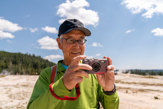 older tourist taking photo 