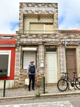 UGC man with backpack by ugly building in Lisbon