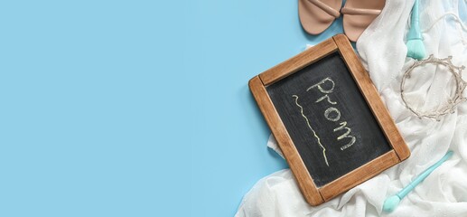 Chalkboard with word PROM, female outfit and makeup brushes on light blue background with space for text, top view © Pixel-Shot