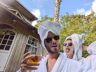 Cool white couple funny selfie with drink