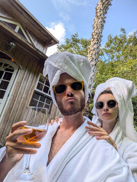 Cool white couple funny selfie with drink