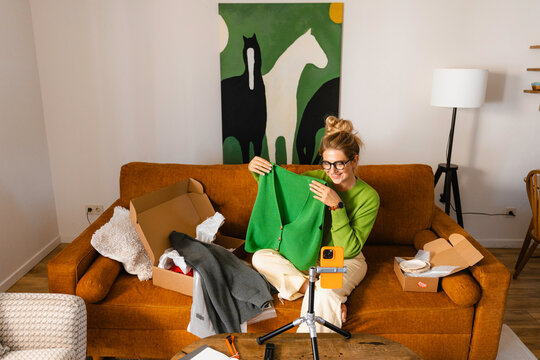 A woman unpacks parcels at home