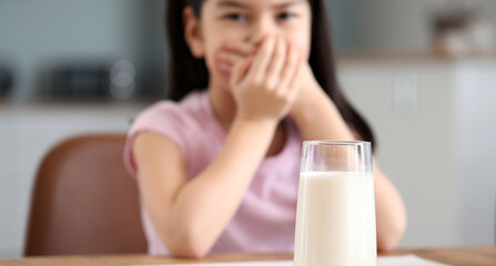 Cute Asian girl with dairy allergy at home