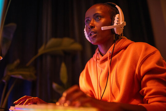 Shocked woman looking at screen while playing video game