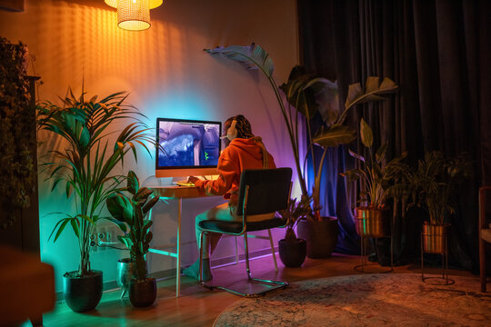 Woman enjoying night playing video games