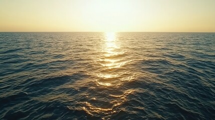 Obraz premium Serene sunset over tranquil ocean waves with gentle colors creating a soothing and peaceful atmosphere