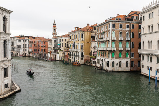gondola with a gondolier rowing on the grand canal of venice in italy