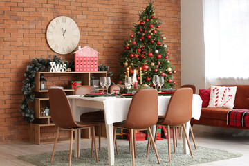 Interior of festive dining room with table served for Christmas celebration