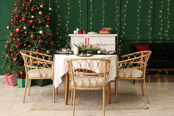 Festive table setting in stylish living room with Christmas tree and fireplace